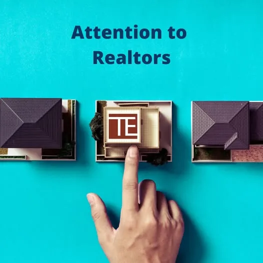 Hand selecting a house model with the Title Experts mark